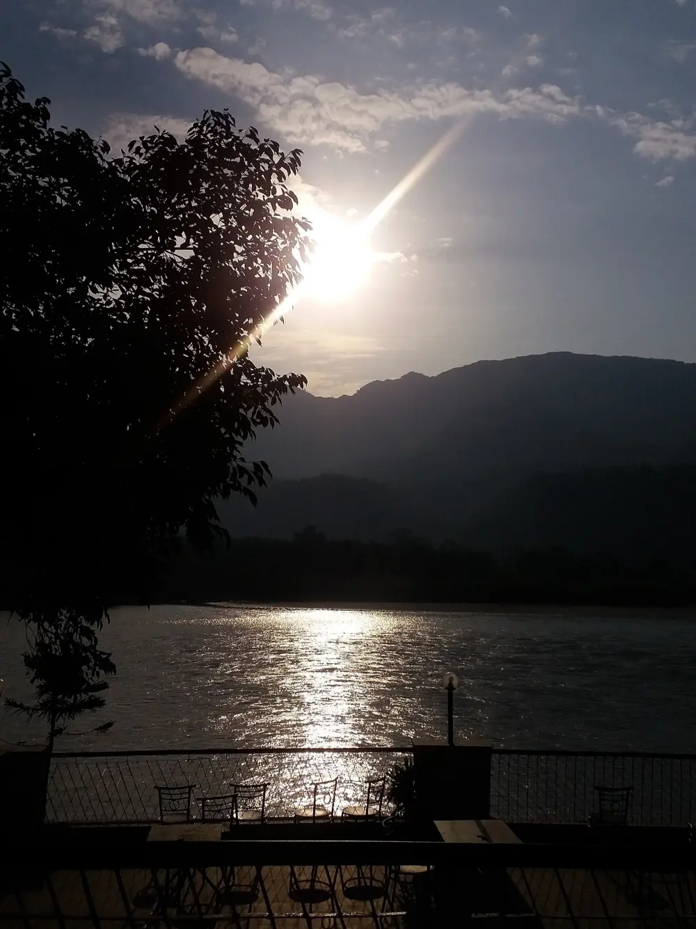 The sun rising over the Ganga at Rishikesh, seen from a riverside terrace